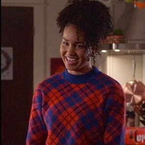 Plaid orange and blue sweater.